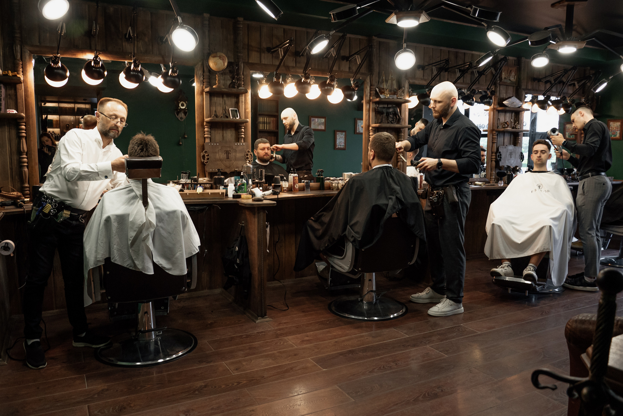 Traditional barber tools including scissors, combs, and a straight razor arranged at a grooming station