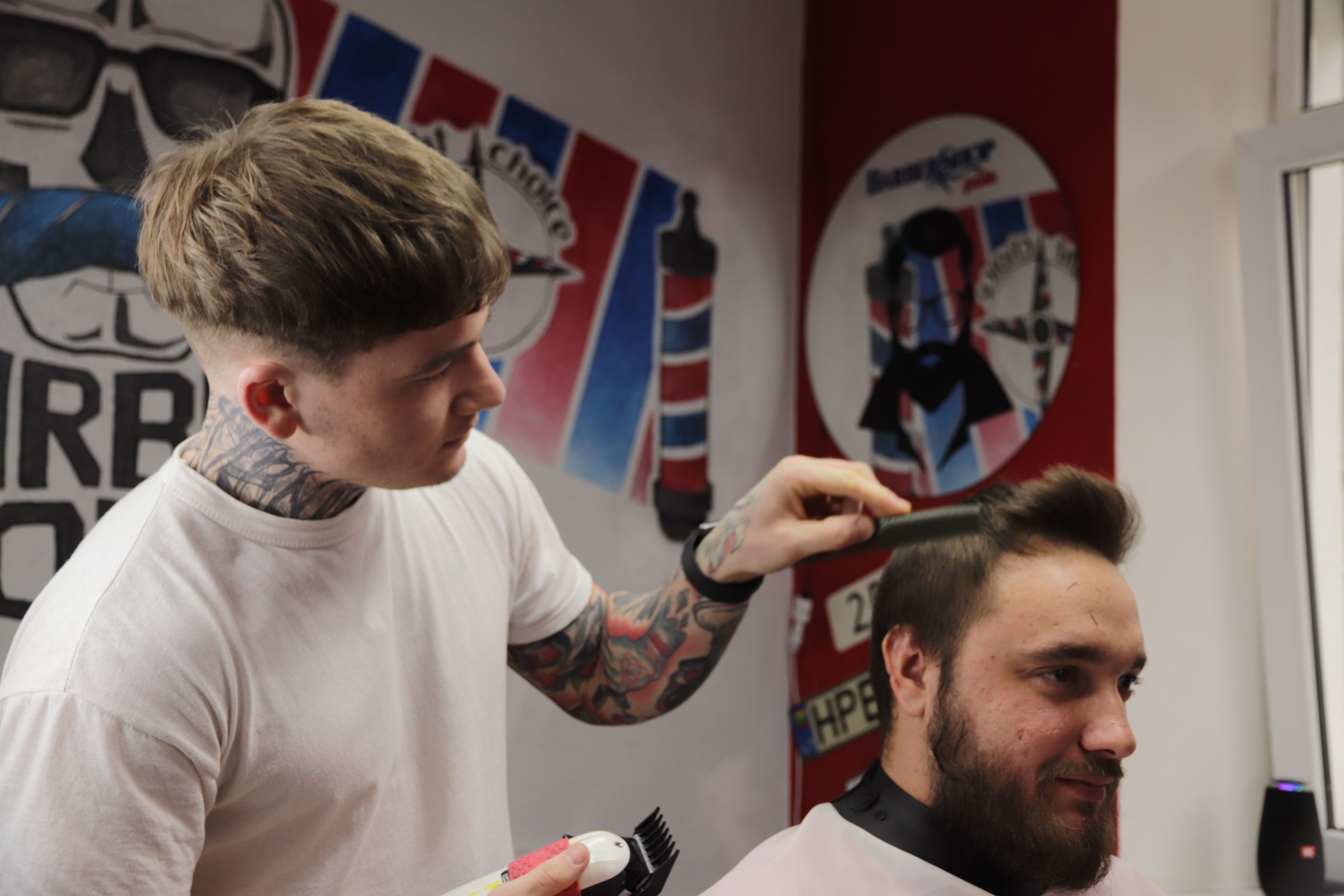 Professional barber tools arranged beside a freshly styled men's haircut in a contemporary barbershop