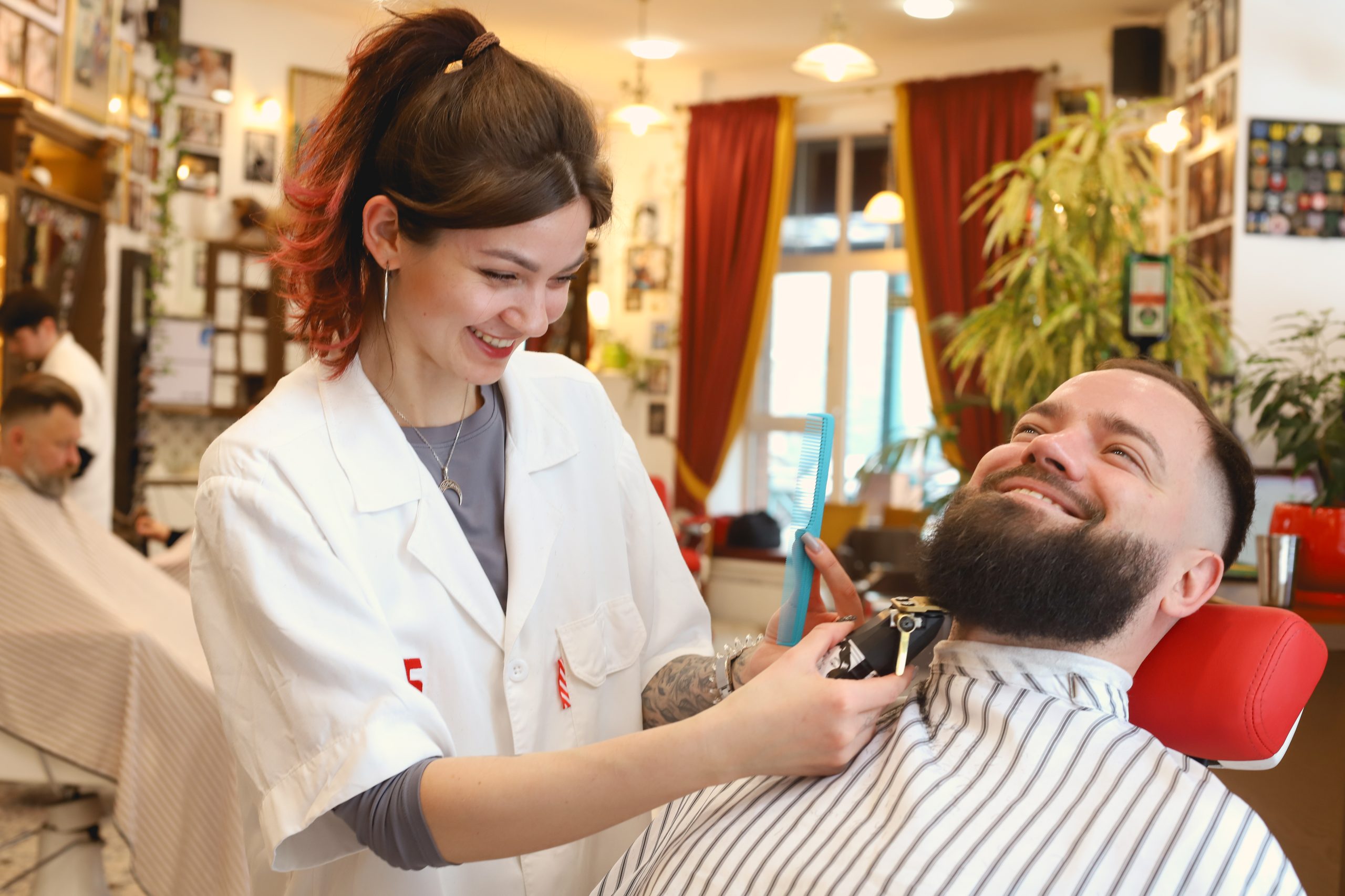 Traditional barber workstation with a straight razor, comb, scissors, and grooming essentials
